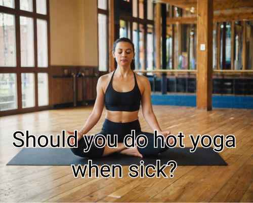 Bikram yoga practice intensifies with woman’s strong pose.